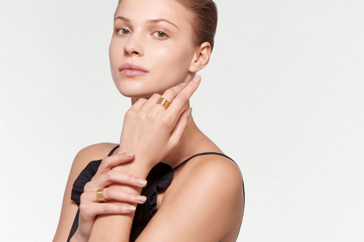 Auvere gold ring and earring from the 22k and 24k jewelry collection on a model