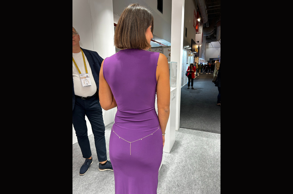 Exhibitor at IJS showing jewelry on her dress