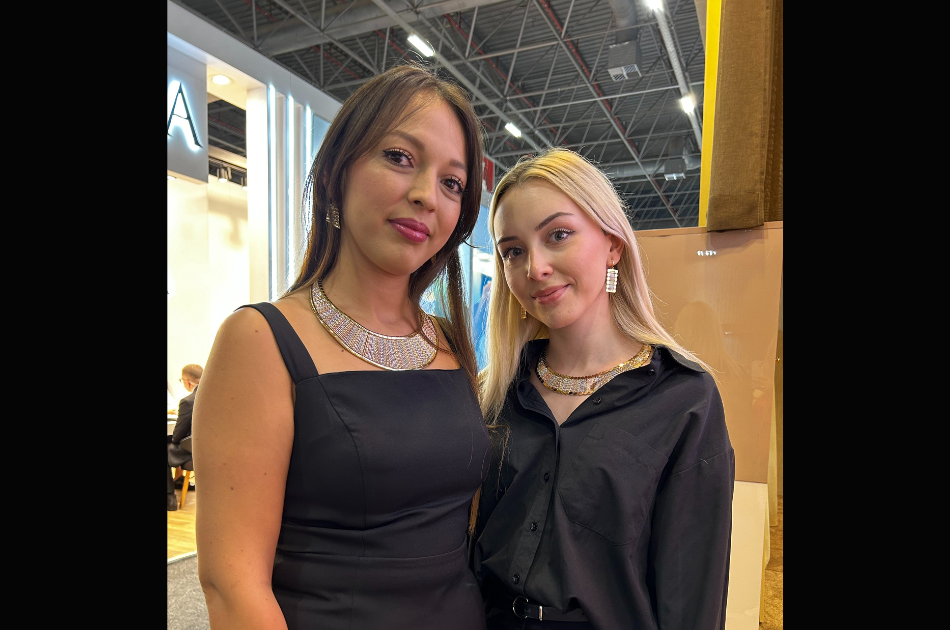 Young models showing gold jewelry at exhibitor booth at Istanbul Jewelry Show